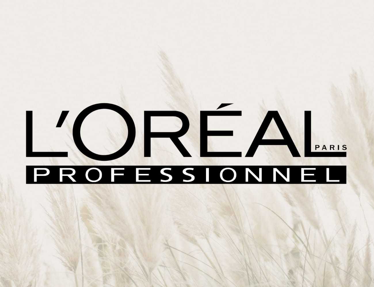 L'Oreal Professionnel logo over a backdrop of beige pampas grass.